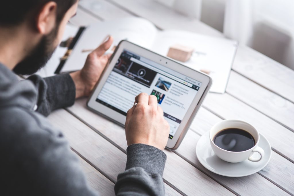 Man Searching ipad for fake news