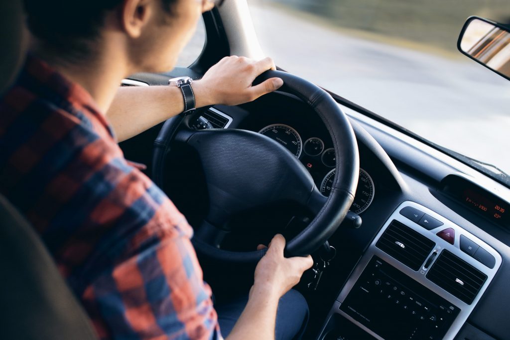 Young Man Driving Car Plaid Shirt