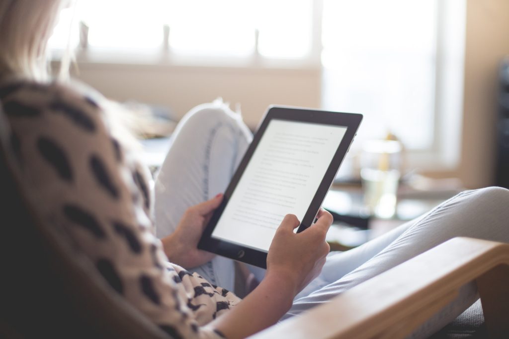 woman-sitting-on-chair-using-black-ipad-headlines-196649